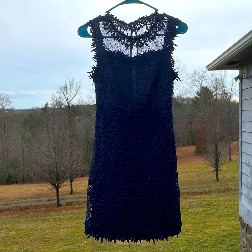 Navy blue dress with lace around the neck and half back lace